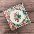 Floral printed paper napkins with vintage colorful flowers on a dark wood background - Red and Blue Flowers