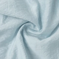 Detailed macro view of light blue ruffled fabric with elegant texture and soft silk sheen - Light Blue