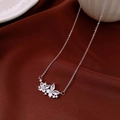 Macro shot of silver 18K gold plated flower necklace on a red velvet background - Butterfly Pendant Necklace (Silver-18K Gold Plated)