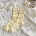 Winter cable knit socks in cream color featuring warm chunky texture and cozy home aesthetic - One Size / Milky Yellow