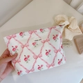 Detailed macro of floral makeup bag with pink ribbon print and simple wish label - Pink Ribbon Lattice Flower