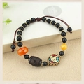 Detailed view of ethnic agate and yak bone beaded bracelet with intricate metal inlays - Ebony: Nepal Buddha Eye Bracelet