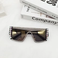 Close-up of oversized sunglasses with colorful rhinestones and black gradient lenses - Luxury Gold