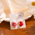 Macro shot of 925 silver polar bear and red Christmas stocking mismatched stud earrings - Polar Bear and Christmas Sock (E3657-2)