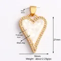 Macro detail of heart charm with white shell mosaic inlay and cubic zirconia stones - Shell-Chip Shell Heart