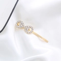 Elegant gold infinity shaped hair clip with sparkling rhinestones on silk background - Infinity Shape