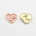 Detailed view of pink enamel heart charms with golden rose motif for DIY jewelry making - Pink-Gold