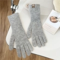 Detail of grey knitted gloves with a small brown leather brand tag on the wrist cuff - One Size / Gray