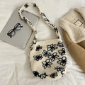 Detail of off-white faux shearling tote bag featuring black flower pattern on white fabric - Off-white Flower
