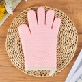 Pink heat resistant silicone oven mitt with anti-slip heart texture on wicker mat - Girl Pink
