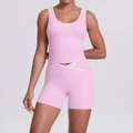 Detail view of pink yoga set with white trim and V-shaped crossover high waist shorts - Sakura Pink