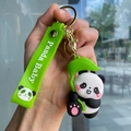 Close-up of cute panda keychain with green silicone strap and Panda Baby text detail - Panda Gen 3 - Style 01