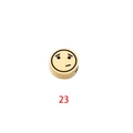 Close-up of golden cylinder bead with laser-engraved skeptical emoji face and red number 23 - Expression 23