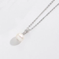 Detail shot of a white pearl necklace with silver chain on white leather background - White Zirconia Pearl (Silver)