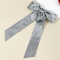 Detail view of a silver-grey velvet bow hair clip with long elegant ribbons on a white disk - Long Ribbon Bow / Silver Gray