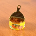 Close-up of miniature canned fruit dollhouse toy with orange segments on wooden surface - Orange Style - No Buckle