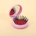 Pink portable travel hairbrush with mirror, folding compact design for easy storage - Pink + Red