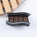 Deep brown marble acetate hair claw clip featuring a creative film roll movie design - Film Roll (C18-2-12)