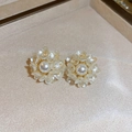 Detail of cream flower earrings with a central pearl on a matte jewelry box - French Vintage Pearl Flower (Silver Pin)