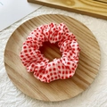 Elastic hair scrunchie featuring a classic red and white checkered fabric pattern - Light Red Plaid