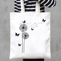 White canvas tote bag featuring black butterfly and dandelion prints with handles - Dandelion & Butterfly (STD707-L)