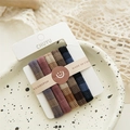 Detail of 6-pack seamless elastic hair ties with plaid textures on a ceramic plate - Textured Grid Dark Colors (5 Pcs/Card)