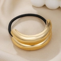 Detail of a black elastic hair tie with a double-layered polished gold metal U-shape charm - Gold Double Layer Smooth
