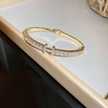 Macro detail of gold-plated stainless steel H-shaped bangle with inlaid cubic zirconia - Zirconia H-Letter Clasp Bangle