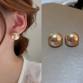 Minimalist pearl stud earrings in champagne gold finish shown on model and flat lay - Champagne Round Style (45#)