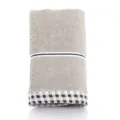 Folded soft cotton bath towel in beige with classic black and white checkered border - Checkered Border - Grey