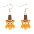 Thanksgiving owl earrings with orange enamel finish and golden hooks on white background - Pilgrim Owl