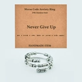 Detail view of Morse Code anxiety ring in 316L stainless steel with Never Give Up card - Never Give Up