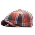 Classic newsboy cap featuring orange and grey plaid pattern in a textured octagonal shape - Orange Plaid