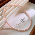 Macro detail of high-luster pink pearl necklace with 925 silver clasp on a jewelry tray - 6mm Pink Single Strand (67#) / Pink