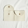 Beige microfiber jewelry pouch with gold snap button in open and closed views - 8*8cm / Off White