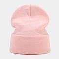 Detail shot of a soft pink knit beanie showing ribbed texture and high-quality warm fabric - Light Pink