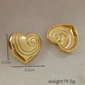 Detail view of gold heart earrings with spiral texture and 2.7cm by 3.0cm size display - Gold