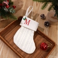 White cable knit Christmas stocking with red embroidered letter M and holly decor - Letter M