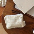 Macro view of cream cotton linen pouch with textured floral jacquard and zipper - Circle Lines Coin Purse
