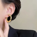 Golden woven textured hoop earrings featuring geometric chain link design on female model - 27# Gold Geometric Woven Texture Earrings (Silver Earring Post)