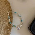 Vintage beaded bracelet featuring blue beads, white pearls and a silver square charm - Blue Beaded Square Tag (SL1083)