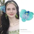 Realistic teal orchid hair clip with pearl accent and elegant floral butterfly design - Cyan