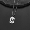 Macro view of silver stainless steel number 9 pendant necklace on a black stone surface - Number 9