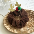 Close-up of brown velvet reindeer antler hair scrunchie with gold bells and plush pom-poms - Brown Antler Bell