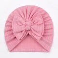 Detail of pink waffle knit baby turban hat featuring a large soft decorative bow - One Size / Pink