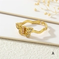 Close-up of butterfly ring with zircon inlay and 18K gold plated texture details - Gold Butterfly (Pink/White Zirconia)