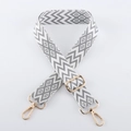 Macro view of geometric jacquard shoulder strap with gold-plated swivel lobster hooks - Light Gold Buckle / Silver Gray