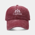Detailed close-up of the vintage washed burgundy cotton fabric and captain embroidery - Adjustable / Burgundy