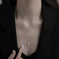 Elegant Y-shaped silver necklace with teardrop pendant worn on a black blazer - Silver Water Drop Necklace