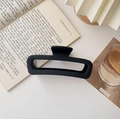Detail of a large matte black square hair claw clip on a desk with books and a glass - Matte Large Square Black